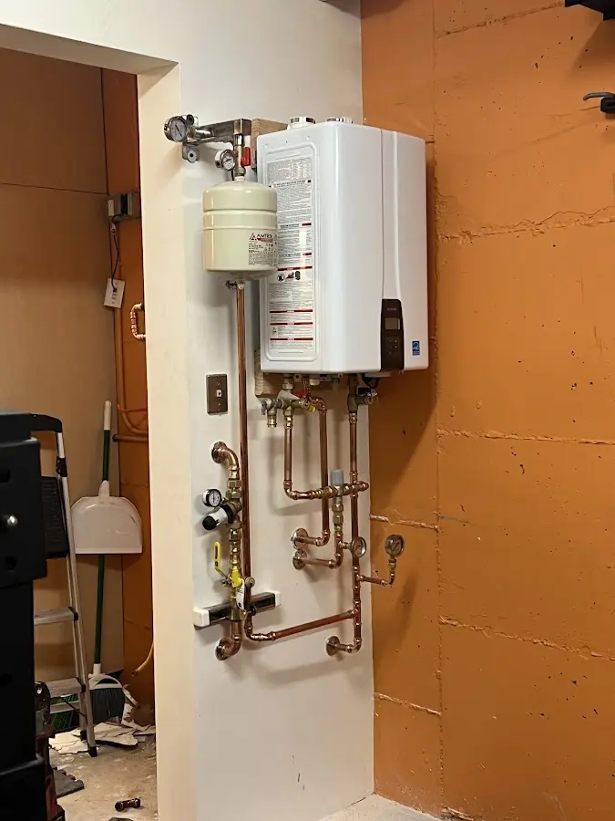 Plumbing technician inspecting water heater connections in Castle Hills